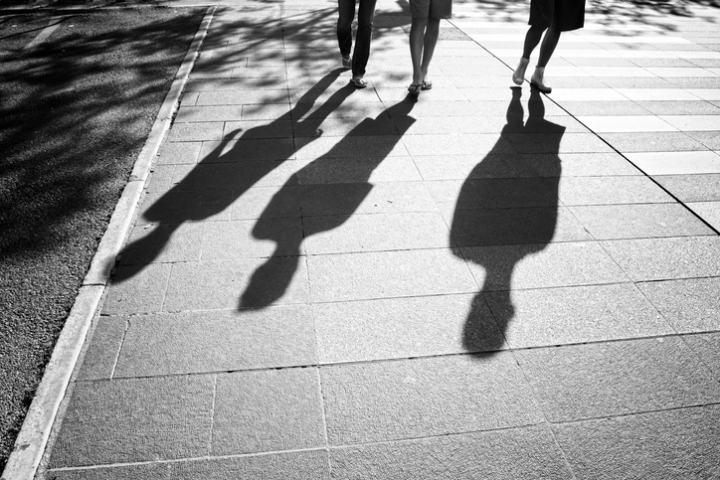 People shadows on sunny city street